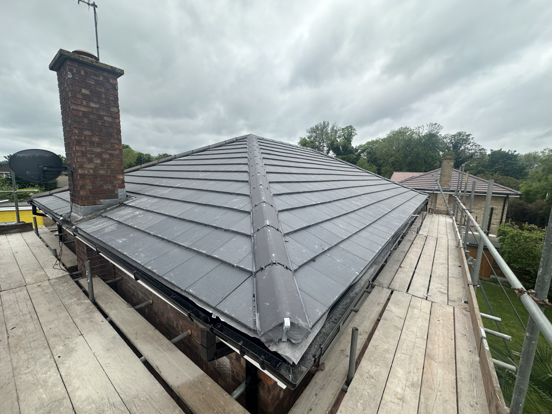 New hipped tiled roof with scaffolding in place